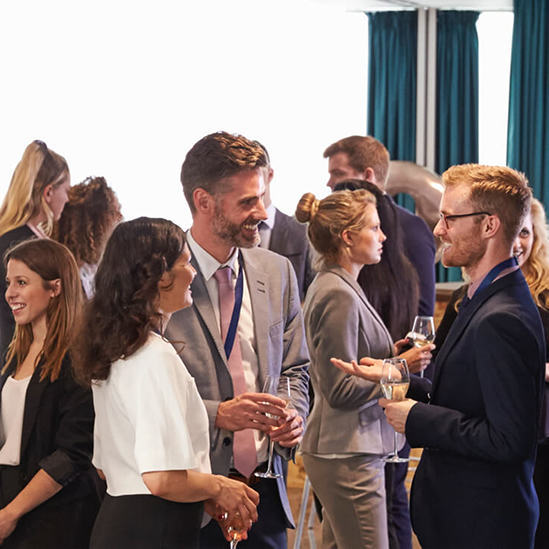 people chatting at a conference