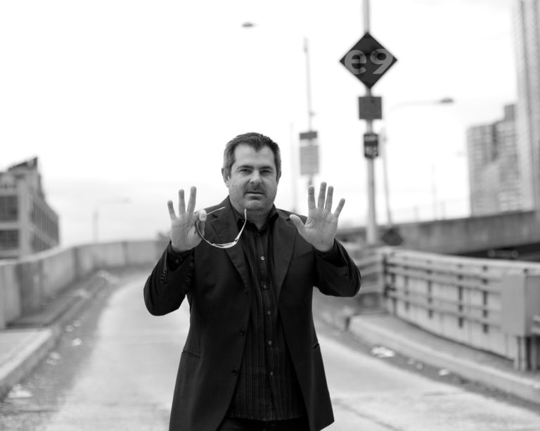 Conrad, founder of e9digital, holding his hands up to stop in the middle of the road