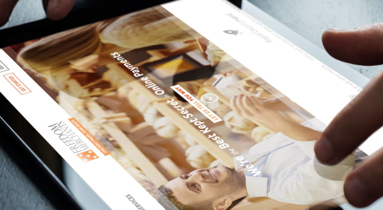 Freedom Merchants homepage on iPad screen